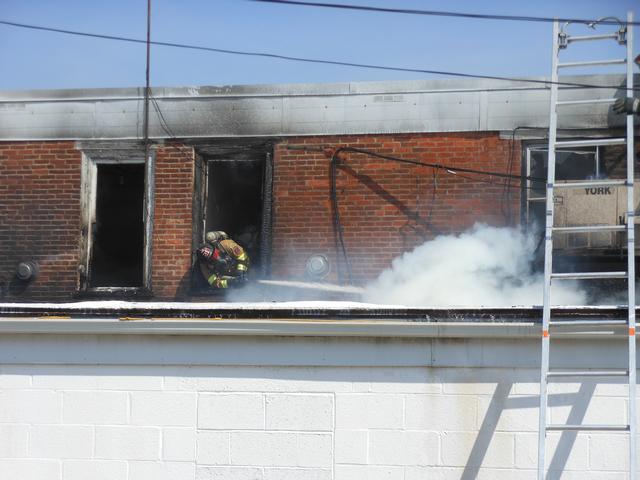 Firefighter Brian Slauch attacking the fire on South Third Street.